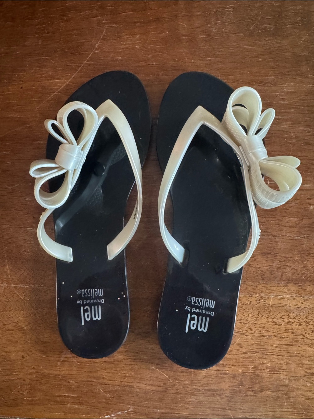 Mel by Melissa Black Flip Flops with Cream Bow Straps